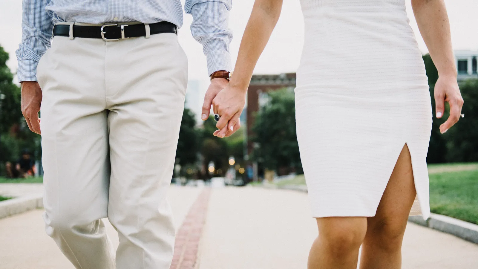 A couple walking hand in hand along a sunny path, representing intimacy, relationships and planning a family with diabetes